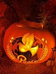 A carved pumpkin with a dove on it
AI-generated content may be incorrect.